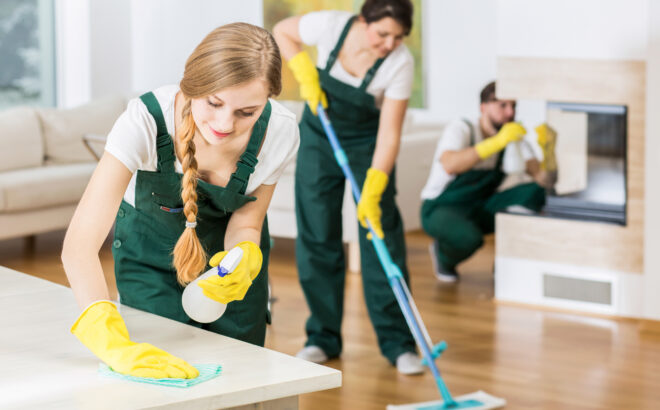 Nothing is better than team work Group of friends as a professional cleaners tiding up big apartment